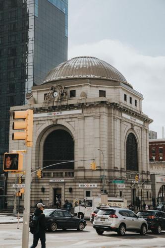 a person crossing a street in front of a building at Leon Hotel LES in New York