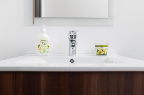 a bathroom sink with a bottle of soap on it at Villa Vista Mar in Funchal