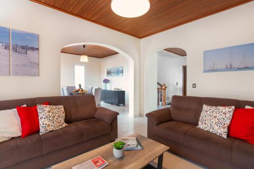 a living room with two brown couches and a table at Villa Vista Mar in Funchal
