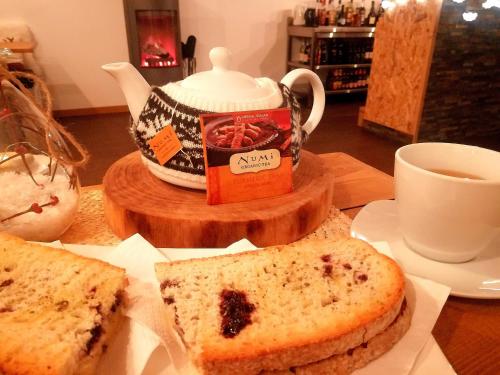 a table with a plate of bread and a cup of tea at Natura Glamping in Alcongosta