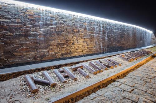a brick wall with a row of pipes next to it at Natura Glamping in Alcongosta