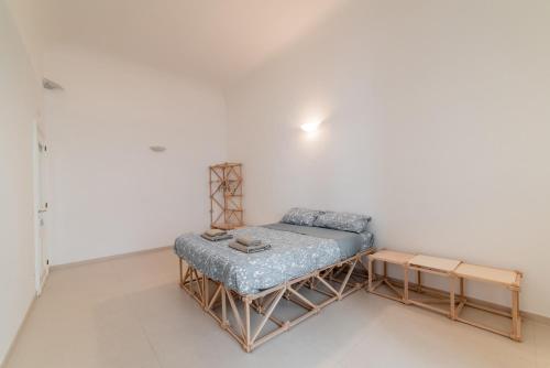 a small room with a bed and a table at Macchia Mediterranea Guest House in Bari