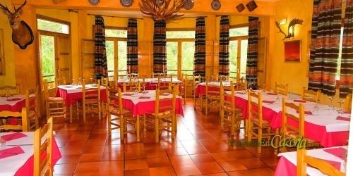 a dining room with tables with red and white tablecloths at MONTE PIEDRA in Arroyo Frio