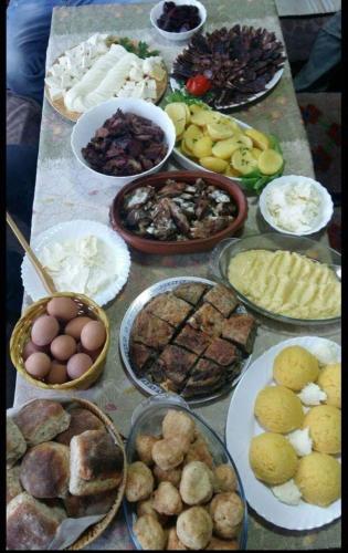 a table topped with lots of different types of food at Organic Family Farm in Žabljak