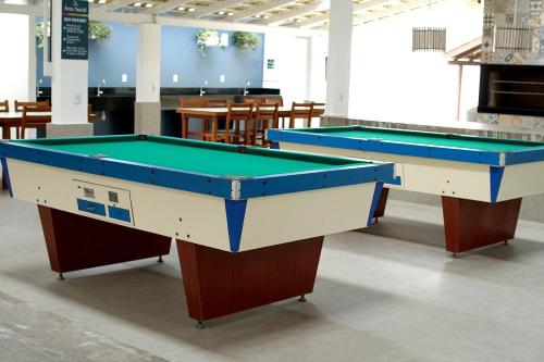 two pool tables on display in a room at Parador Tropical in Bombinhas