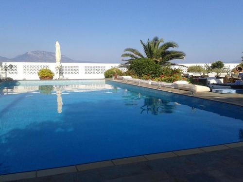 a large blue swimming pool with a white fence at Nerantza Villa Jolimax in Nerátza