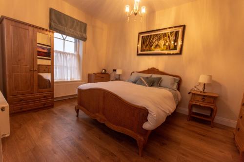 a bedroom with a large bed and a window at The Gatelodge in Dungiven