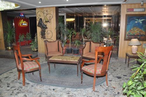 a group of chairs and tables in a lobby at Caesars Palace Hotel in Cairo