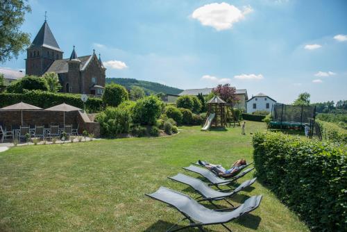 a group of lounge chairs sitting on a lawn at Haus Engel in Burg-Reuland