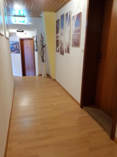 a hallway with a hard wood floor and a door at Garni-Hotel Mühletal in Stein am Rhein