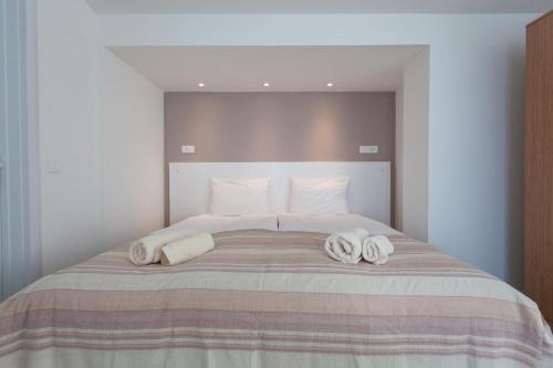 a bedroom with a large bed with towels on it at Villa Jordan in Ohrid