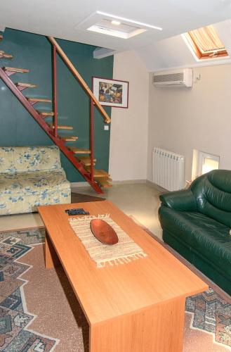 a living room with a coffee table and a green couch at Apartments Skadarlija in Belgrade