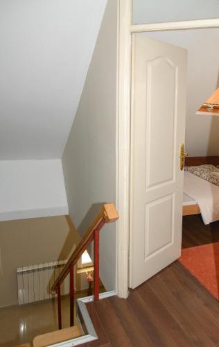 a stairway with a white door and a bedroom at Apartments Skadarlija in Belgrade