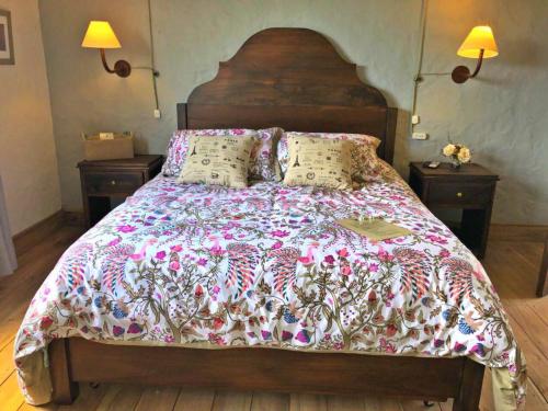 a bed with a blanket and pillows on it at Casa Santamaria Hotel Campestre in Jericó