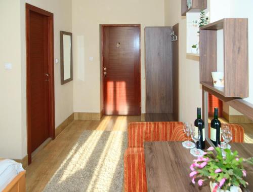 a living room with a table and a door at Apartments Skadarlija in Belgrade