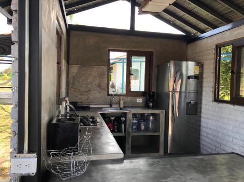 a kitchen with a stainless steel refrigerator in a building at Finca Hotel Brasilia in La Tebaida
