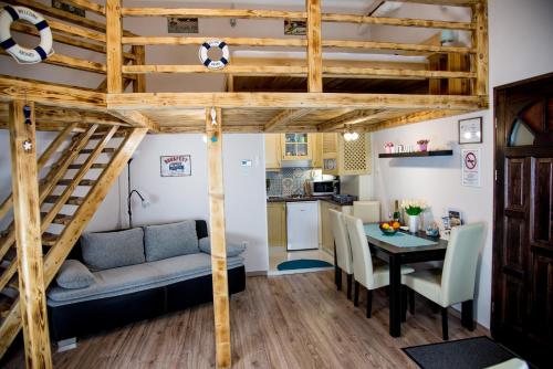 a room with a loft bed and a table and a kitchen at Mirage Apartments Váci Street in Budapest