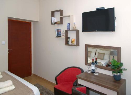 a hotel room with a bed and a desk and a television at Apartments Skadarlija in Belgrade