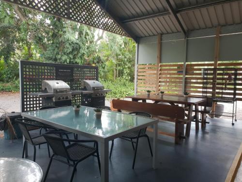 a room with tables and a grill in it at Beerwah Motor Lodge in Beerwah