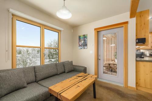 a living room with a couch and a table at The Mountain Project #2 in Rossland