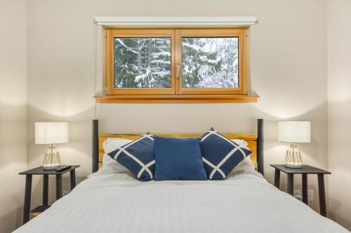 a bedroom with a large bed with two night stands at The Mountain Project #2 in Rossland