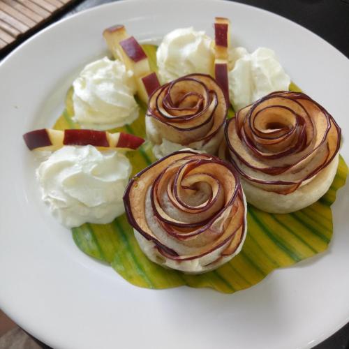 a plate of cupcakes with whipped cream and whipped cream at Le Passe-Temps in Tha Lane Bay