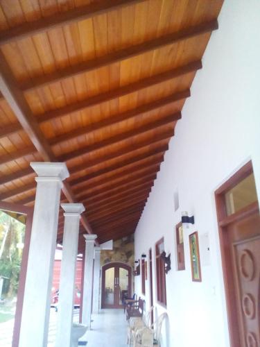 a hallway with a wooden ceiling in a building at Orchid Dream in Bentota