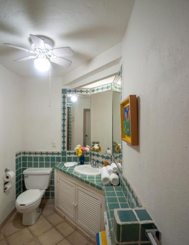 a bathroom with a toilet and a sink and a mirror at Ocean Front, 3 bedroom, 3 bathroom, Casa Natalia, Playa Esmeralda in Puerto Vallarta