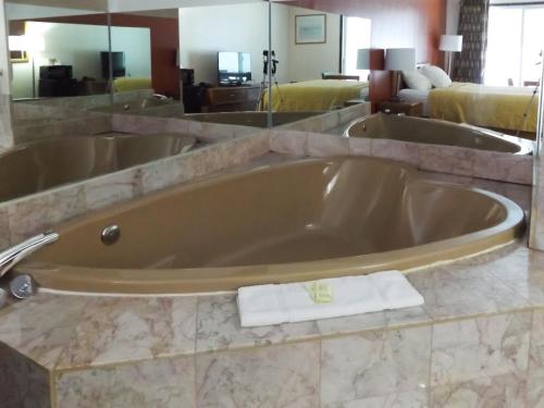 a large bath tub in a hotel room at Manistee Hotel in Manistee