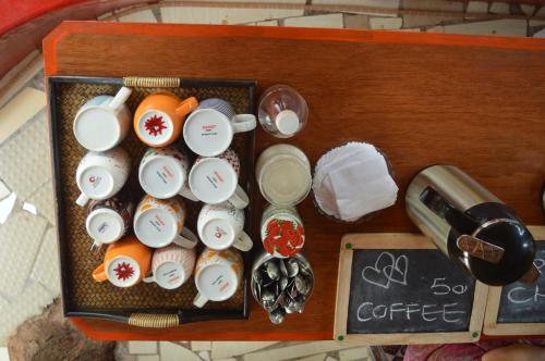 a lunch box with cups and cups on a table at Namaste Yoga Farm in Gokarna
