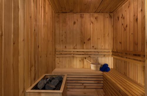 a wooden sauna with a wooden tub filled with logs at Citadines Central Binh Duong in Thuan An