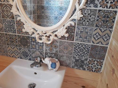 a bathroom with a white sink and a mirror at Cyprus Glamping Park in Ayios Theodhoros