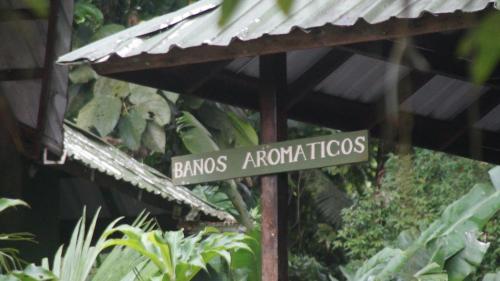 a street sign in the middle of a garden at Casa Colibrí in Nuquí