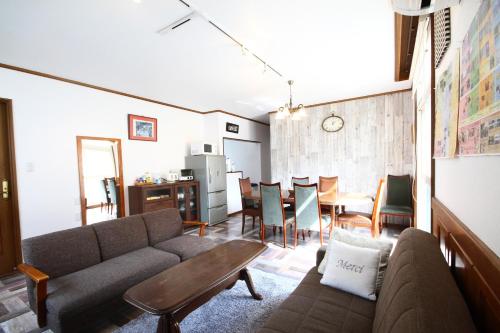 a living room with a couch and a table at kODATEL コダテル 札幌大通公園 301 in Sapporo