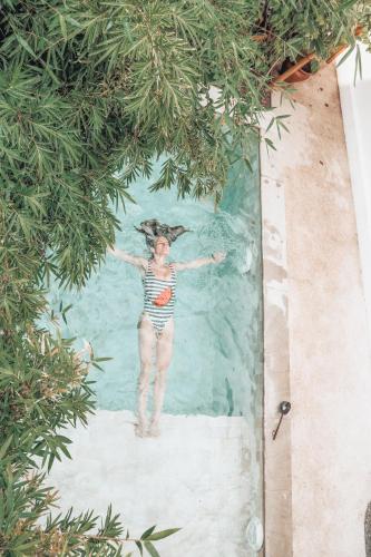 a woman standing in the water in a swimming pool at Sea Breeze Villas - Gili Air, Lombok in Gili Air