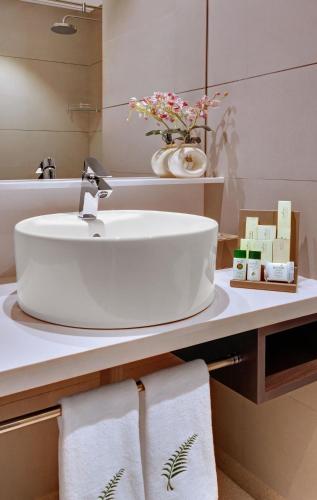 a bathroom with a sink and a counter with towels at The Fern Kesarval Hotel & Spa, Verna Plateau - Goa in Verna