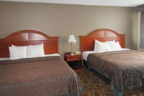 una camera d'albergo con due letti e due lampade di Clarion Inn ad Appleton