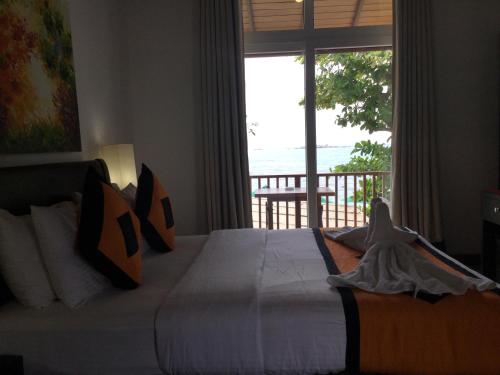a bedroom with a large bed with a view of the ocean at Joe's Resort Unawatuna in Unawatuna