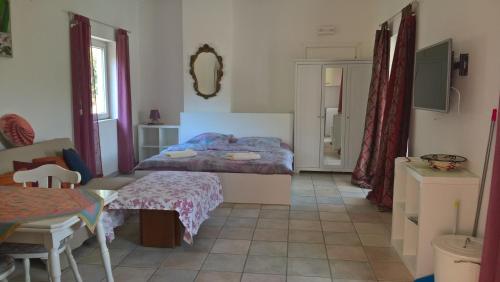a bedroom with a bed and a table in a room at Ferienappartement Angelika in Arzachena