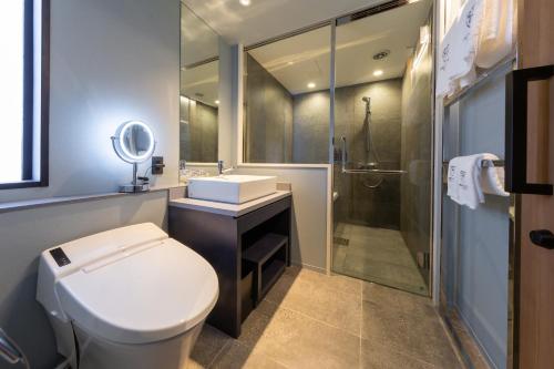 a bathroom with a toilet and a sink and a shower at The Royal Park Canvas - Ginza 8 in Tokyo