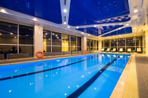 a swimming pool on a cruise ship at night at Novotel Ulaanbaatar in Ulaanbaatar