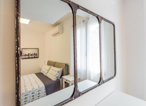 a mirror in a small bedroom with a bed at Loft in Venice in Venice