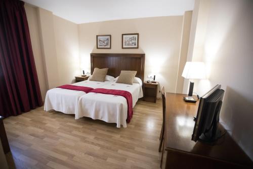 Säng eller sängar i ett rum på Hotel Arcco Ubeda