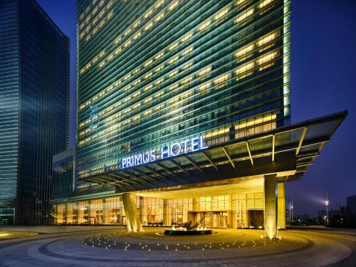 a building with a sign on the side of it at Primus Hotel Nanchang International Expo City in Nanchang