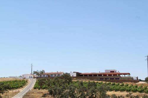 a road in the middle of a field with a building at Casa da Urra in Urra