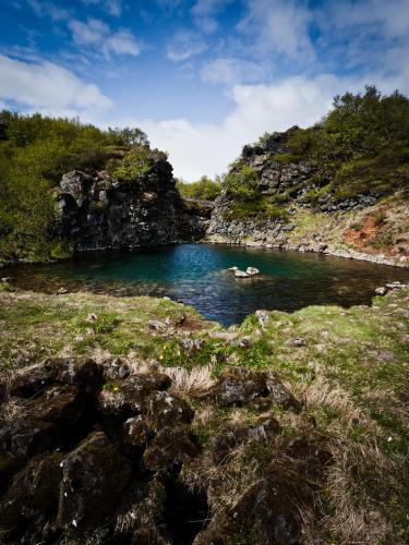 a river with a group of people in the water at Hótel Bifröst in Bifrost
