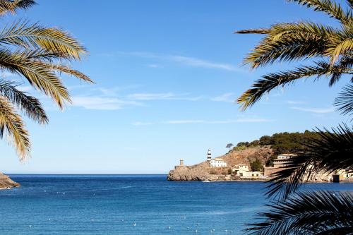 a view of the ocean from a palm tree at Hotel Marina in Port de Soller