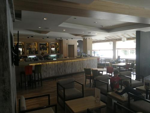 a restaurant with a bar and people sitting at tables at Apartments MARAS - Angella Konaci in Kopaonik