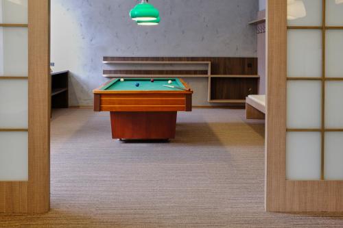 a pool table in the middle of a room at Hotel GTC 3* superior in Bílovec