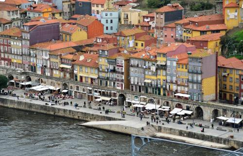 a group of buildings next to a river at RVA - Gustave Eiffel Apartments in Porto